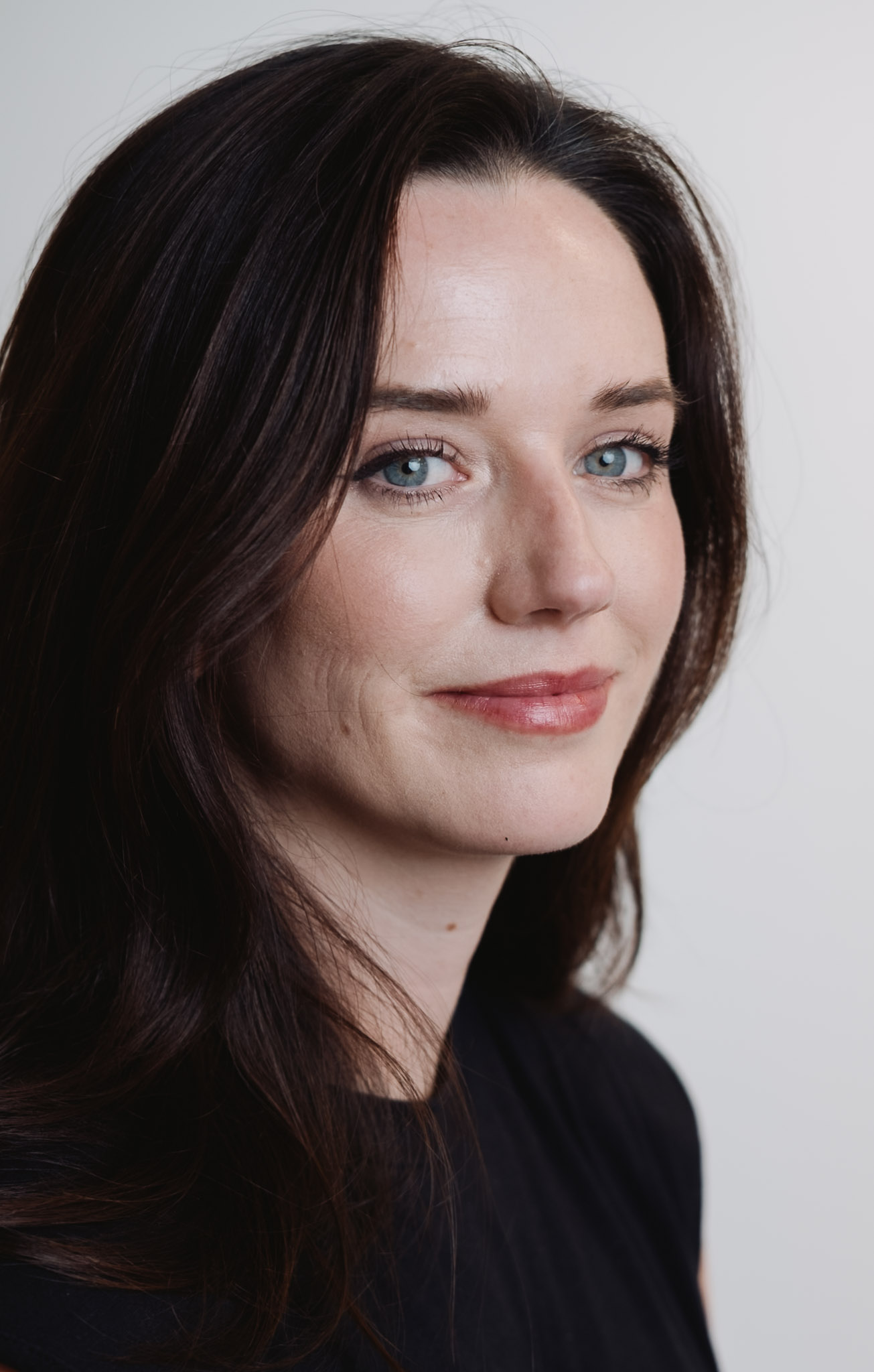 Professional portrait — studio light, consistent style.